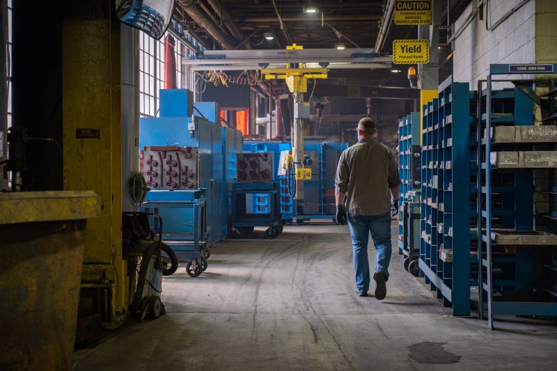 employee walking through ductile iron shop